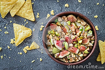 Raw chopped figs, walnuts, pistachios and honey with soft cheese in a bowl Stock Photo