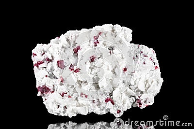 Raw cinnabar or cinnabarite mineral stone in front of black background, mineralogy and pigments Stock Photo