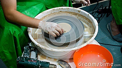 A raw clay pot in the hands of a potter. Workshop in the pottery workshop. Editorial Stock Photo