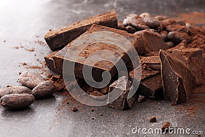 Raw cocoa beans, cocoa powder and chocolate pieces Stock Photo