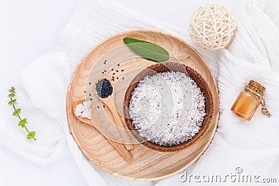 Raw coconut and coconut essential oils with sea salt and herbs. Stock Photo