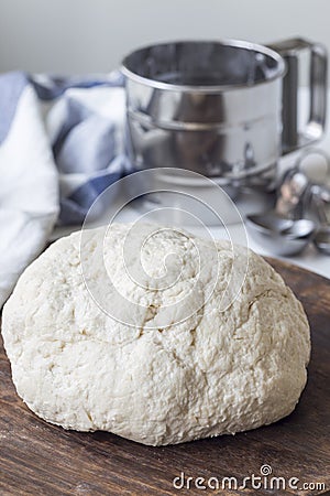 Raw cottage cheese dough on wooden board, vertical. Making savoury cottage cheese pies with minced meat Stock Photo