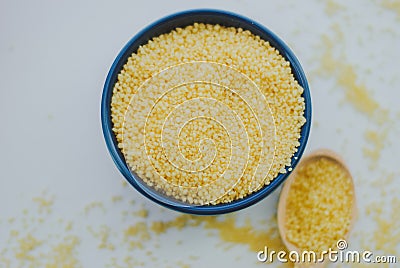 Raw couscous in the bowl Stock Photo