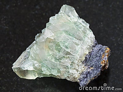 raw crystalline fluorite gemstone on dark Stock Photo