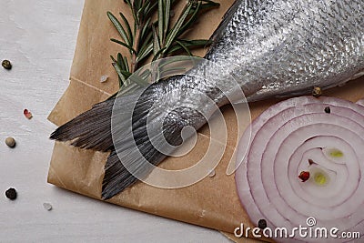 Raw dorado fish, spices and onion on white wooden table, flat lay Stock Photo