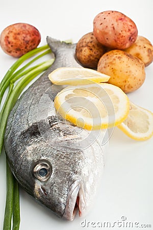 Raw dorado fish with vegetables Stock Photo