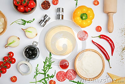 Raw dough and ingredients for pizza on white background, top view Stock Photo