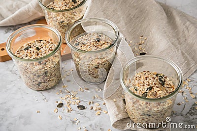 Raw dough of wholegrain bread with chia, oats, flaxseeds, sunflower and pumpkin seeds in glass jar for canning and prepper long Stock Photo