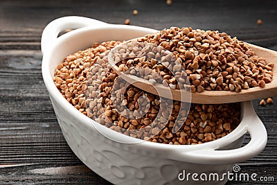 Raw buckwheat grains in white bowls Stock Photo