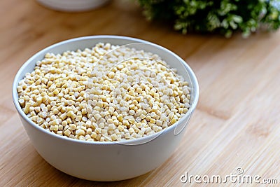 Raw Dry Organic Couscous in a Bowl. Turkish Kuskus Stock Photo