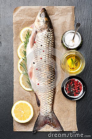 Raw fish carp with herbs and spices Stock Photo