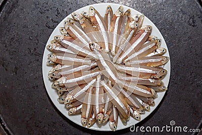 Raw fish,A manjuba, pititinga, ginga or manjubinha (Anchoviella lepidentostole), Top view Stock Photo