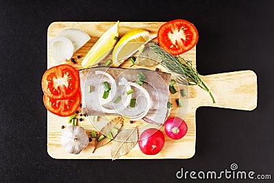 Raw fish meat, organic radish, lemon, onion and spice top view with closeup on cutting board. Fresh natural, organic, healthy and Stock Photo