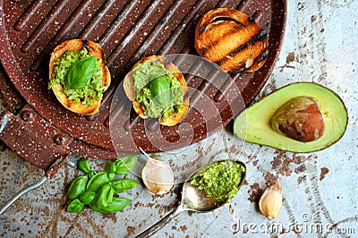 Raw, fresh alkaline food with avocado and basil pesto with garlic Stock Photo