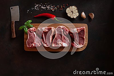 Raw fresh Lamb Meat ribs and seasonings on dark wooden background Stock Photo
