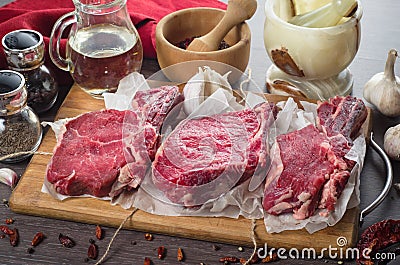 Raw fresh meat rib eye steak composition on wooden background Stock Photo