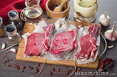 Raw fresh meat rib eye steak composition on wooden background Stock Photo