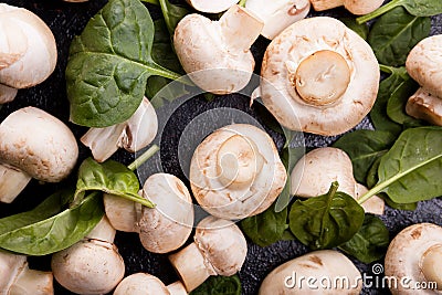Raw fresh mushrooms and spinach leaves Stock Photo