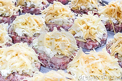 Raw fresh pork cutlets with fried onions and boiled eggs and potatoes Stock Photo