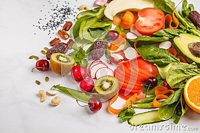 Raw fresh vegetables, fruits, berries, nuts on a white background. Healthy food background. Healthy vegan food concept. Stock Photo