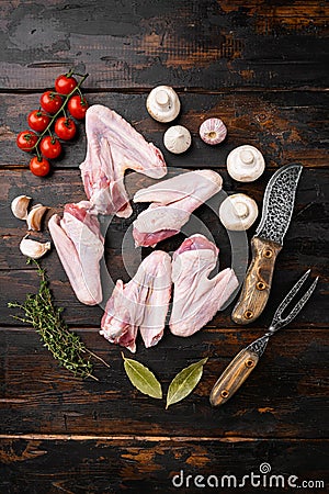 Raw goose wings, on old dark wooden table background, top view flat lay Stock Photo