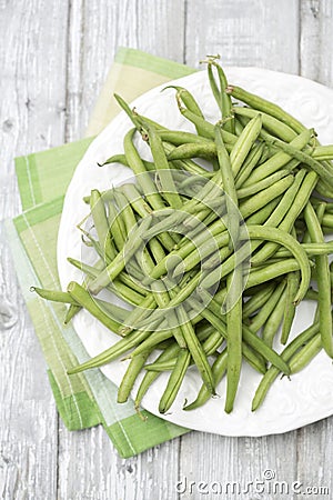 Raw green beans (Phaseolus vulgaris) on plate Stock Photo