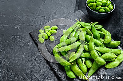 Raw Green edamame soybeans. Black background. Top view. Copy space Stock Photo