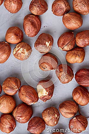 Raw hazelnut on heap isolated on white background, selective focus, shallow depth of field Stock Photo