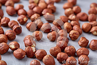 Raw hazelnut on heap on white background, selective focus, shallow depth of field Stock Photo