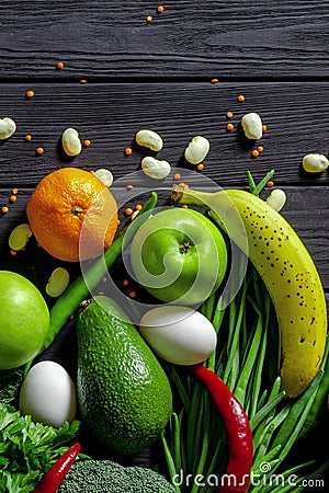 Raw healthy food, grocery set on a black wooden table Stock Photo