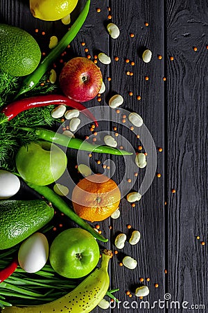 Raw healthy food, grocery set on a black wooden table Stock Photo