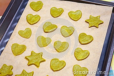 Raw homemade cookies with green tea matcha in star shape and heart shape on baking sheet Stock Photo