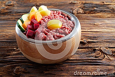 Raw ingredients in bawl on wooden table Stock Photo