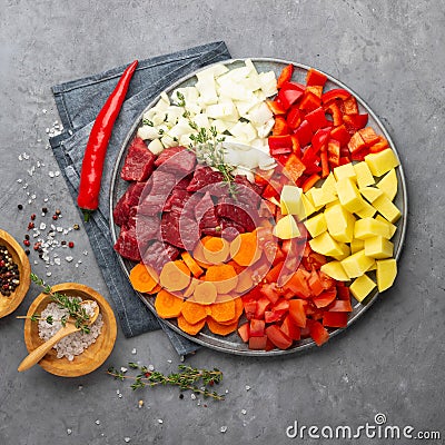 Raw ingredients for cooking goulash or stew - meat, vegetables and spices. Stock Photo