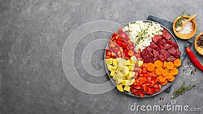 Raw ingredients for cooking goulash or stew - meat, vegetables and spices. Stock Photo