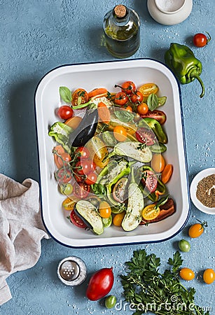 Raw ingredients for lunch - fresh chopped vegetables in the pan on a blue background, top view. Stock Photo