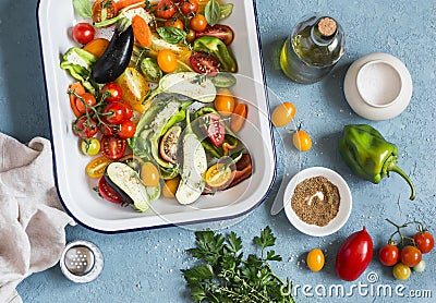 Raw ingredients for lunch - fresh chopped vegetables in the pan on a blue background, top view. Stock Photo