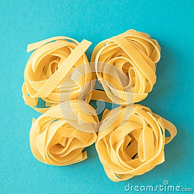 Raw italian pasta fettuccine nest. Spaghetti Tagliatelle nests top view Stock Photo