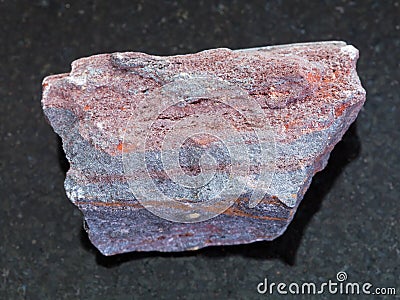 raw jaspilite (ferruginous quartzite) on dark Stock Photo