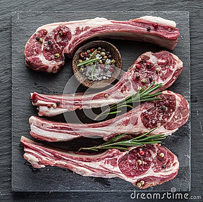 Raw lamb chops with garlic and herbs. Stock Photo