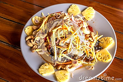 Raw mango salad with peanuts, crispy fish, sour and spicy Stock Photo