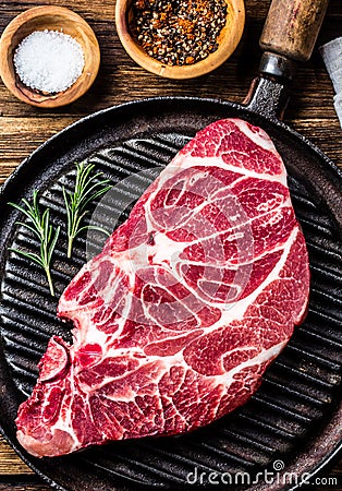 Raw marbled beef steak on grill pan Stock Photo