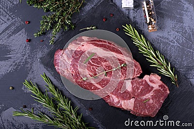 Raw marbled beef steak, herbs and spices Stock Photo