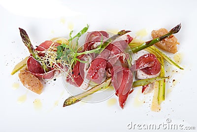 Raw marinated green asparagus with smoked duck breast Stock Photo