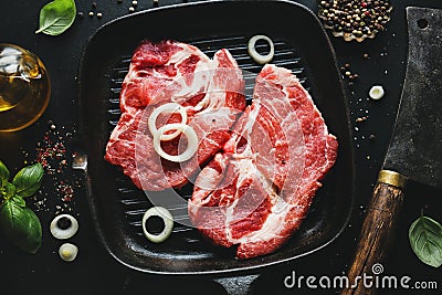 Raw meat on pan on dark Stock Photo