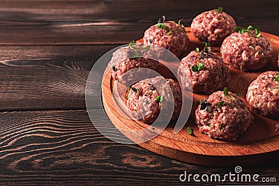 Raw meatballs, with micro greenery, on a cutting board, homemade, rustic, no people, Stock Photo