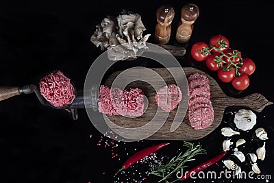 Raw meatballs is ready to be cooked. Raw Minced Beef Butcher Meatballs, Turkish name; Kasap Kofte - on a black background Stock Photo