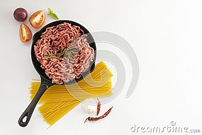 Raw micned beef uncooked meat with spaghetti basil onions white bacground spaghetti bolognaise top view Stock Photo