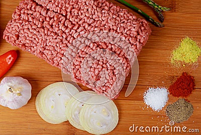 Raw minced meat beef with various spices on a wooden board Stock Photo