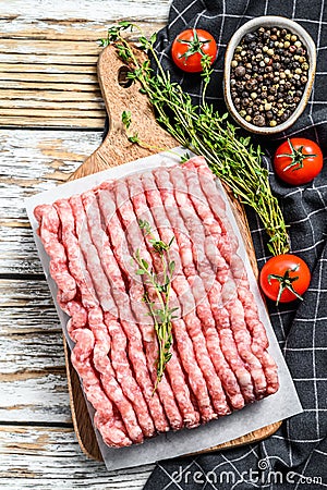 Raw minced pork on a chopping Board. Organic ground meat, forcemeat. White background. Top view Stock Photo